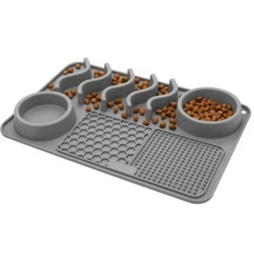 Grey silicone slow feeder pet mat with two bowls, wavy channels and textured lick pads, filled with kibble